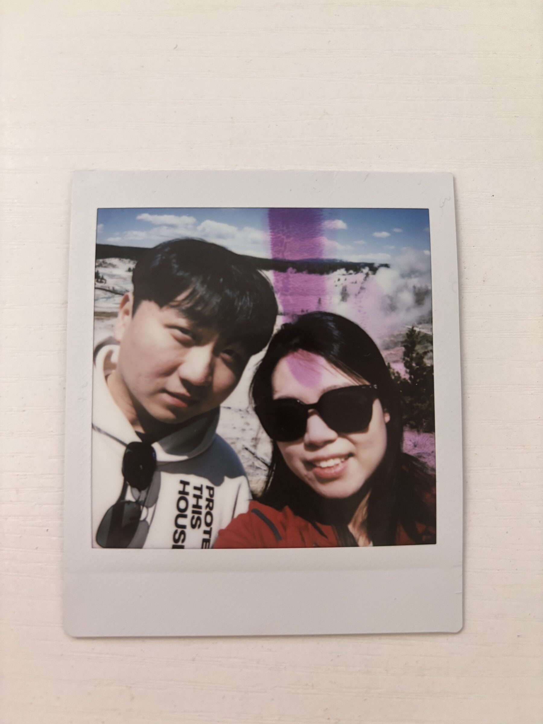A couple smiling together in a printed photo